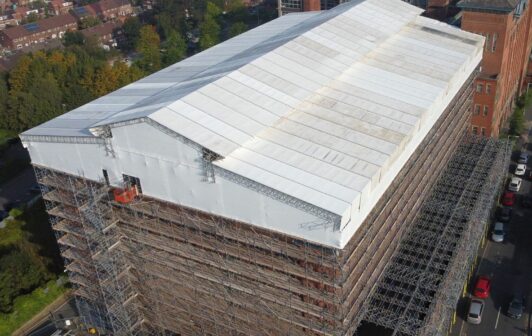 An aerial view of Houldsworth Mill's roof covered in scaffolding.