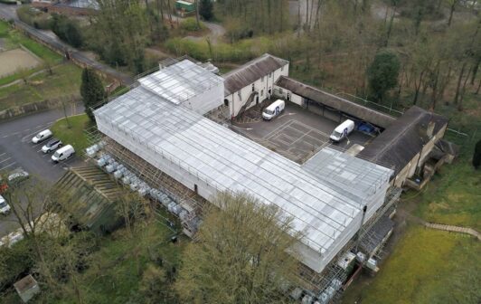 An image of 'The Stables' covered in scaffolding.